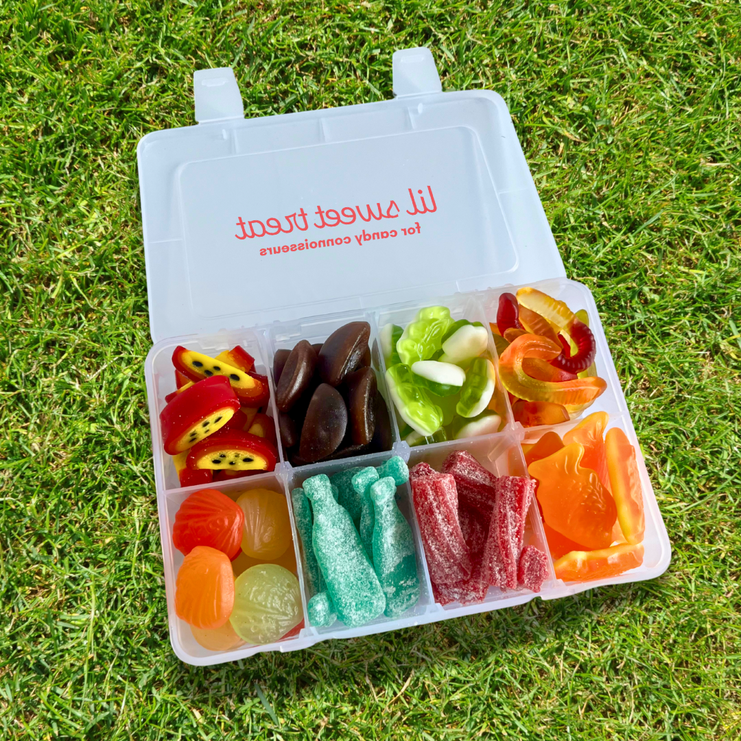 Summer gummy snacklebox filled with assorted colorful candies in a resealable plastic container, perfect for July 4th celebrations, beach days, and summer travel.