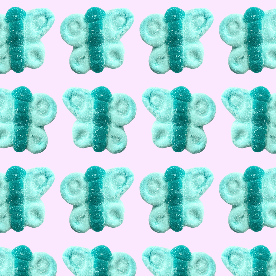 Pattern of blue butterfly-shaped candies on a pink background
