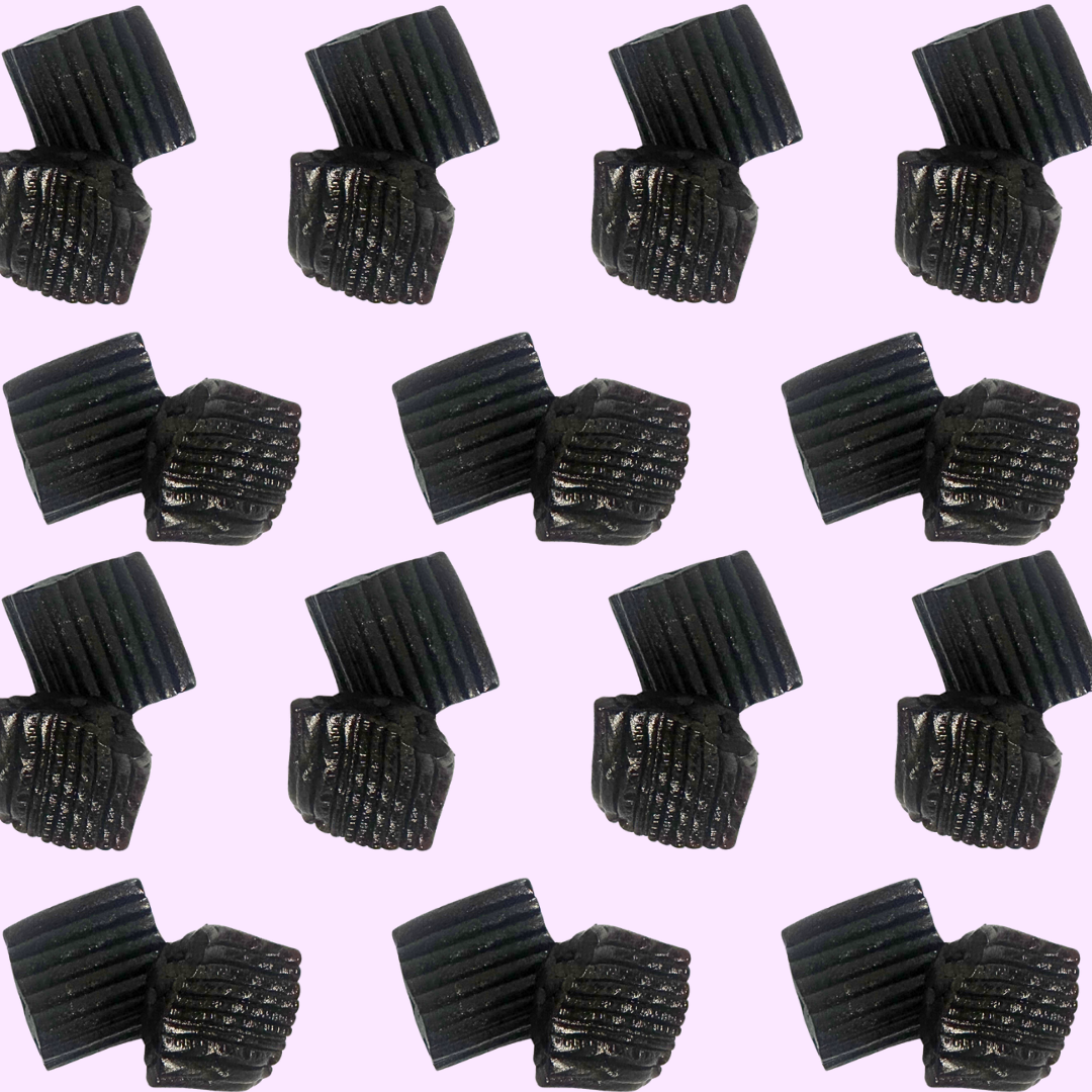 Pattern of black textured objects on a pink background