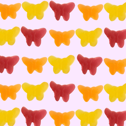 butterfly shaped gummies from Sweden over a pink background 