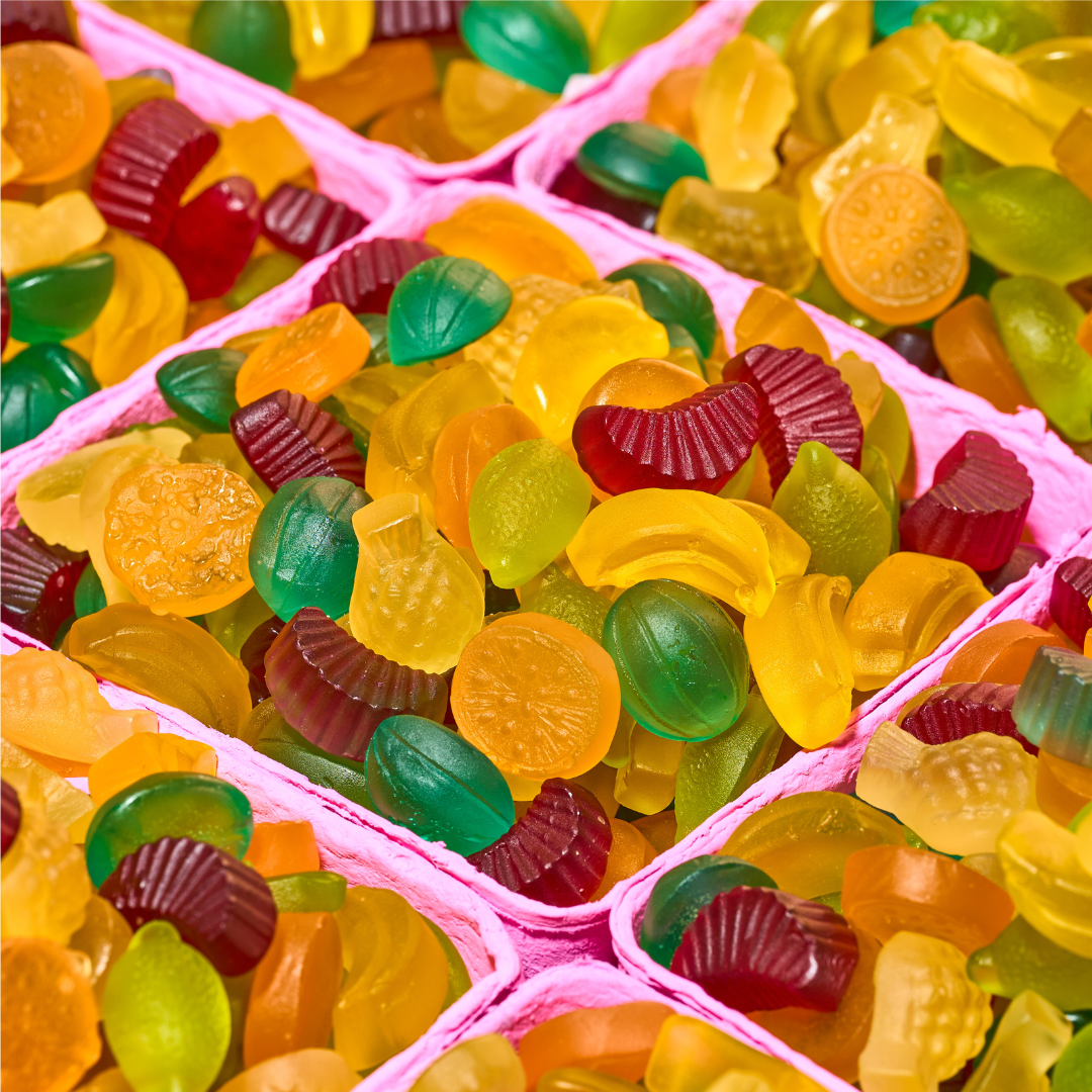 Colorful gummy candies in pink trays
