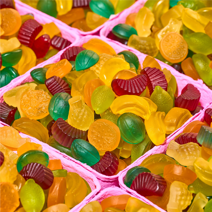 Colorful gummy candies in pink trays