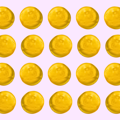 Pattern of yellow tropical flavored gummies on a pink background