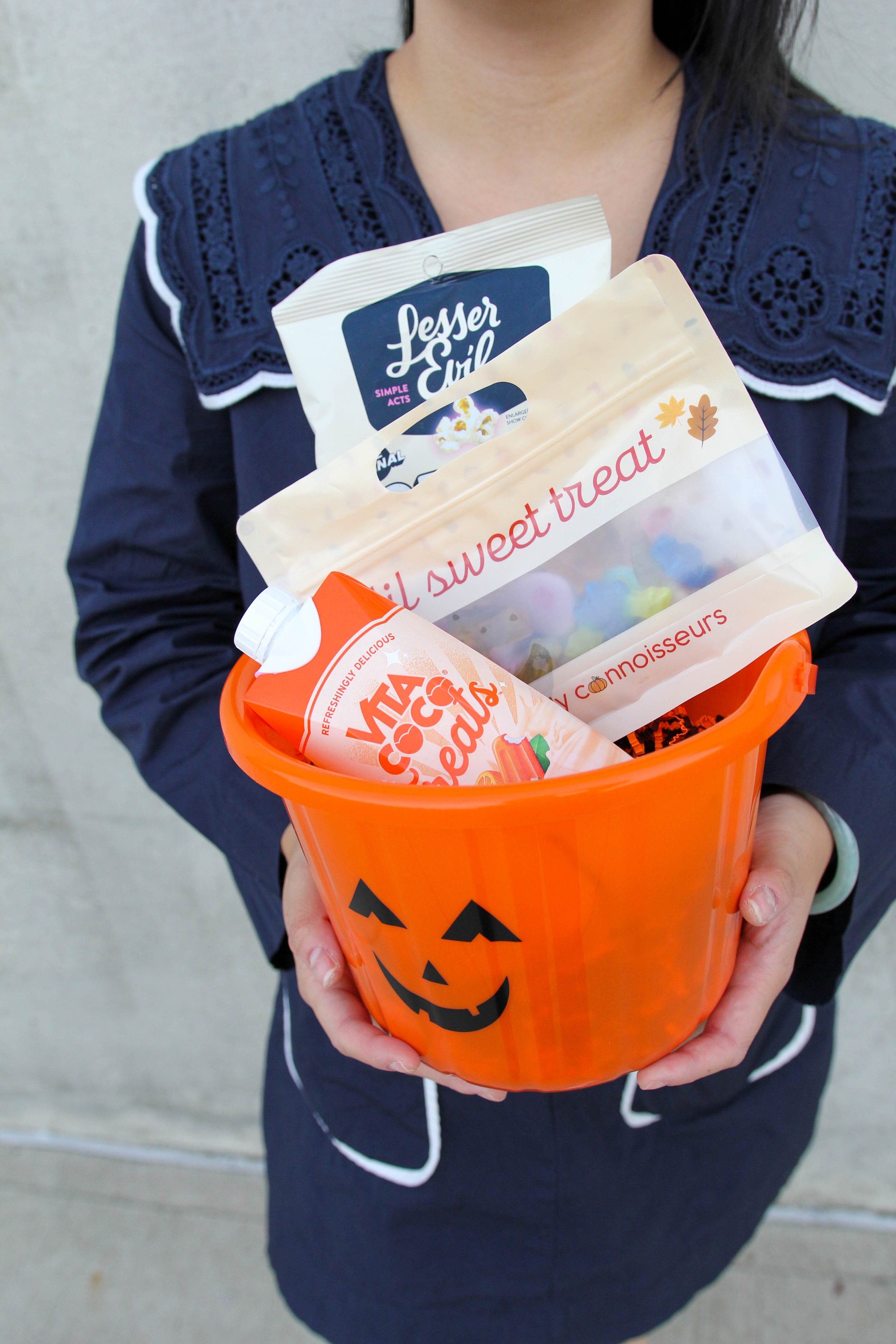lil sweet treat boo baskets: a pumpkin bucket with lil sweet treat candy, vita coco flavored coconut water and lesser evil halloween popcorn 