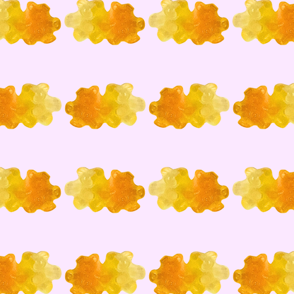 Pattern of orange and yellow gummy bears on a light purple background