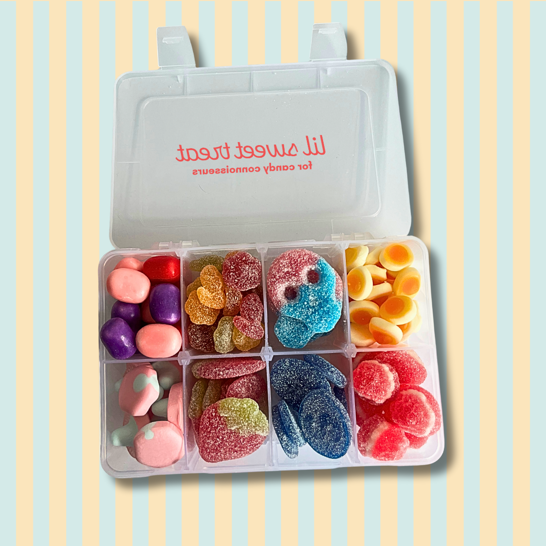 Colorful gummy candies in a divided container on a striped background