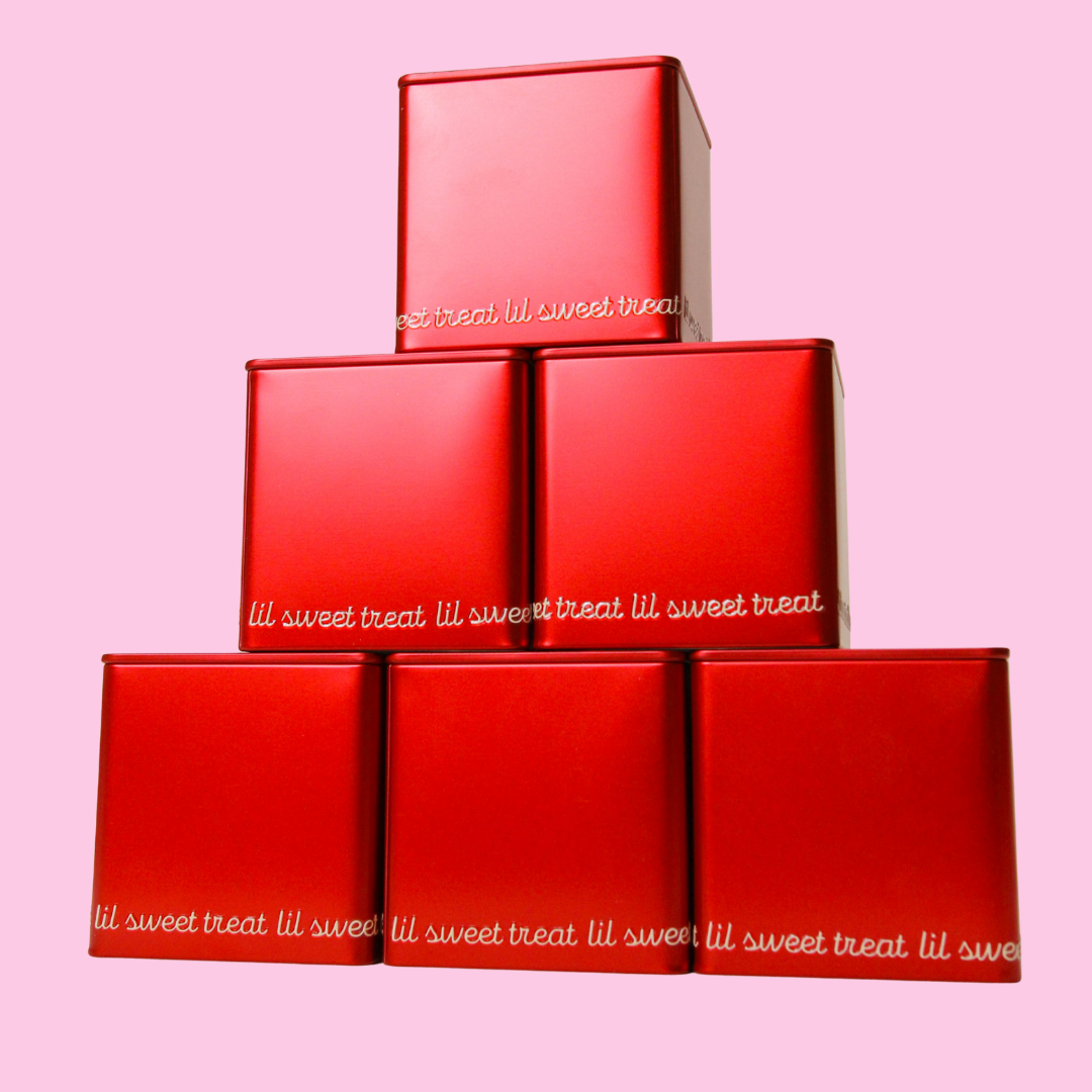 Stack of red boxes with 'lil sweet treat' text on a pink background
