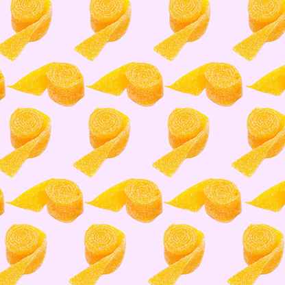 Pattern of yellow mango belt candies from the Netherlands on a pink background