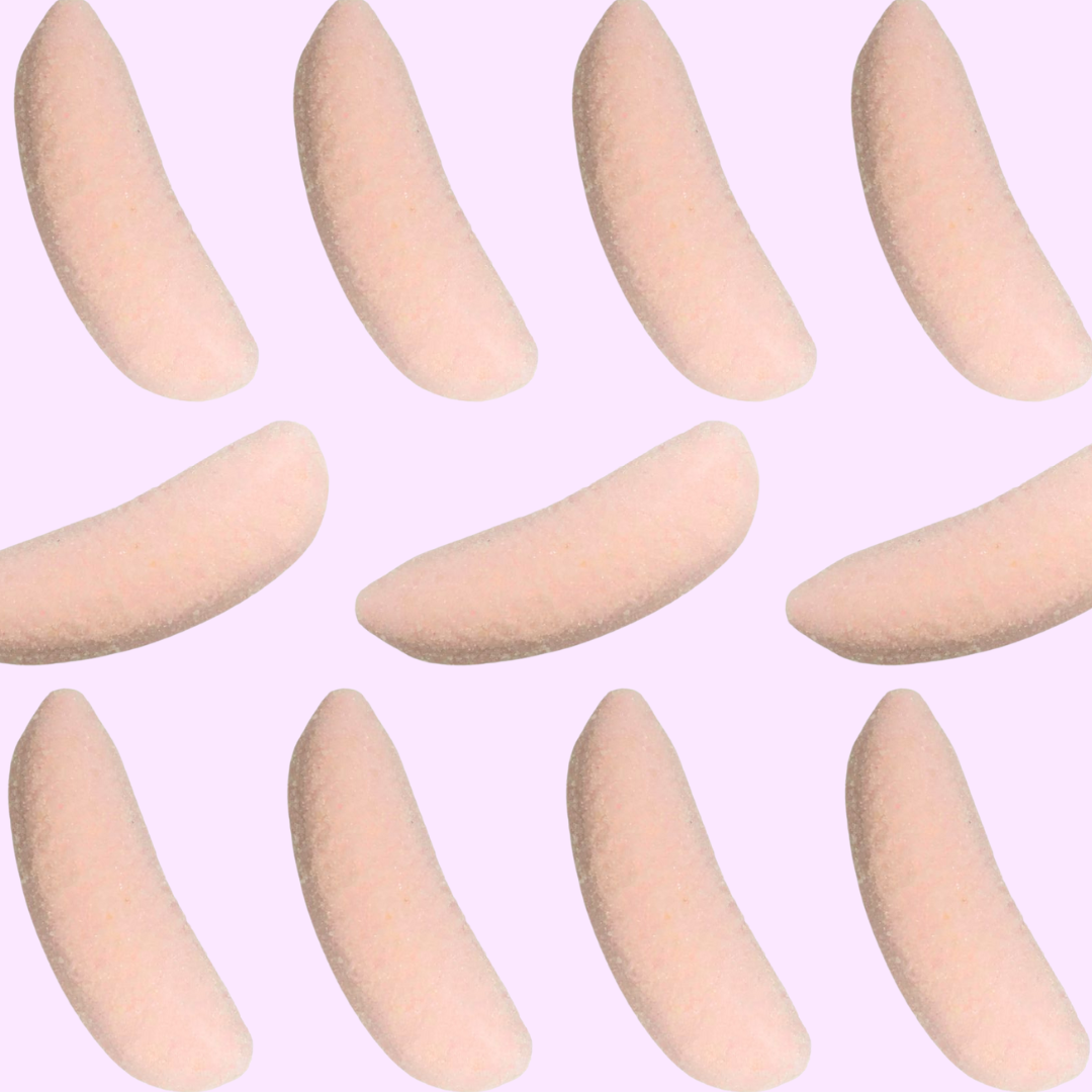 pink sour strawberry banana mushrooms arranged in a grid on a light purple background