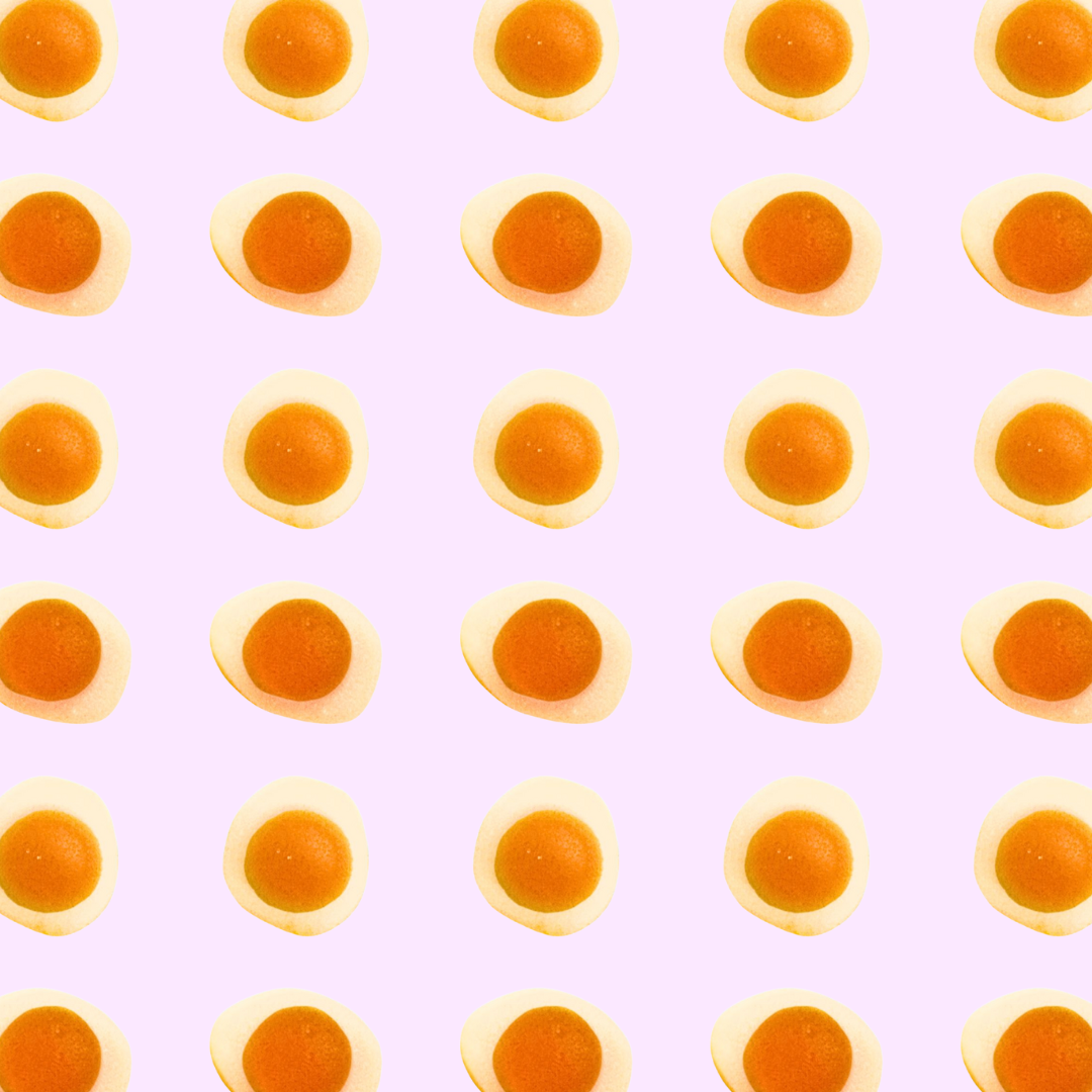 Pattern of gummy eggs on a light purple background