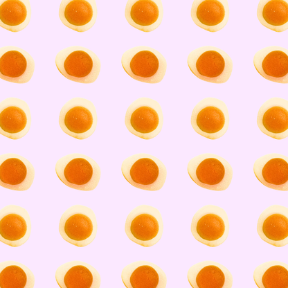 Pattern of gummy eggs on a light purple background